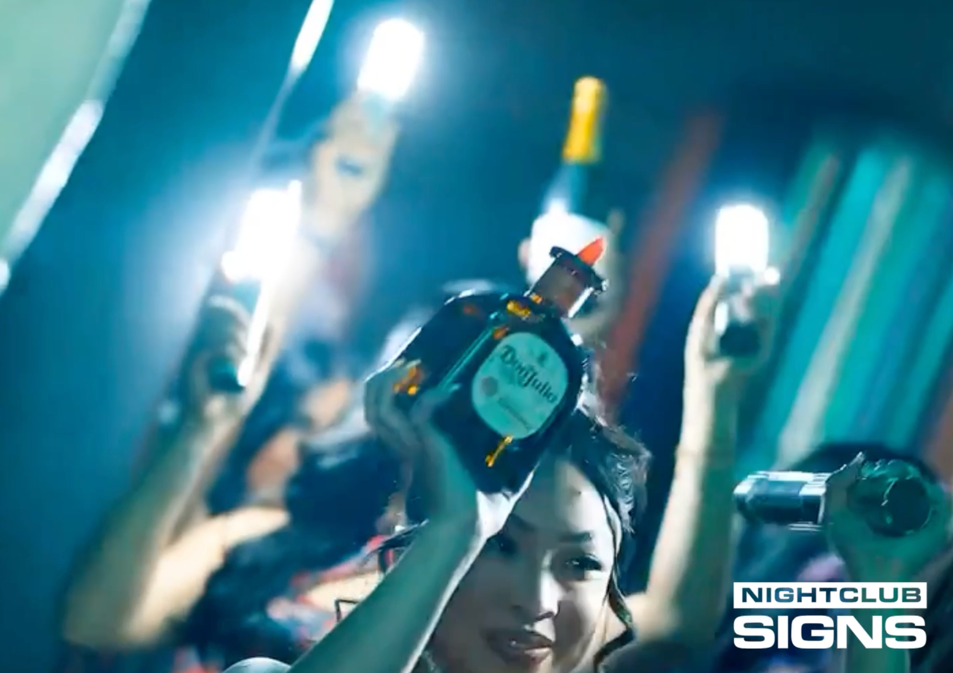 Load video: LED bottle sparklers flashing during a nightclub bottle service reveal by bottle girls