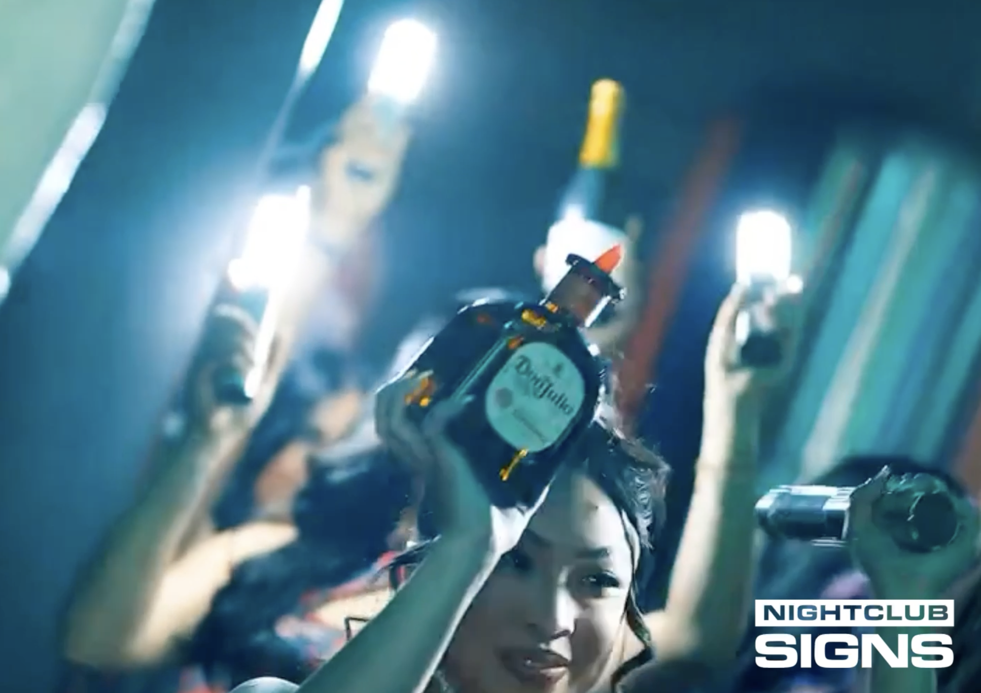 Load video: LED bottle sparklers flashing during a nightclub bottle service reveal by bottle girls