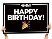 holding up a happy birthday sign
