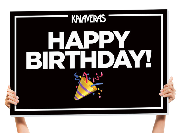 holding up a happy birthday sign